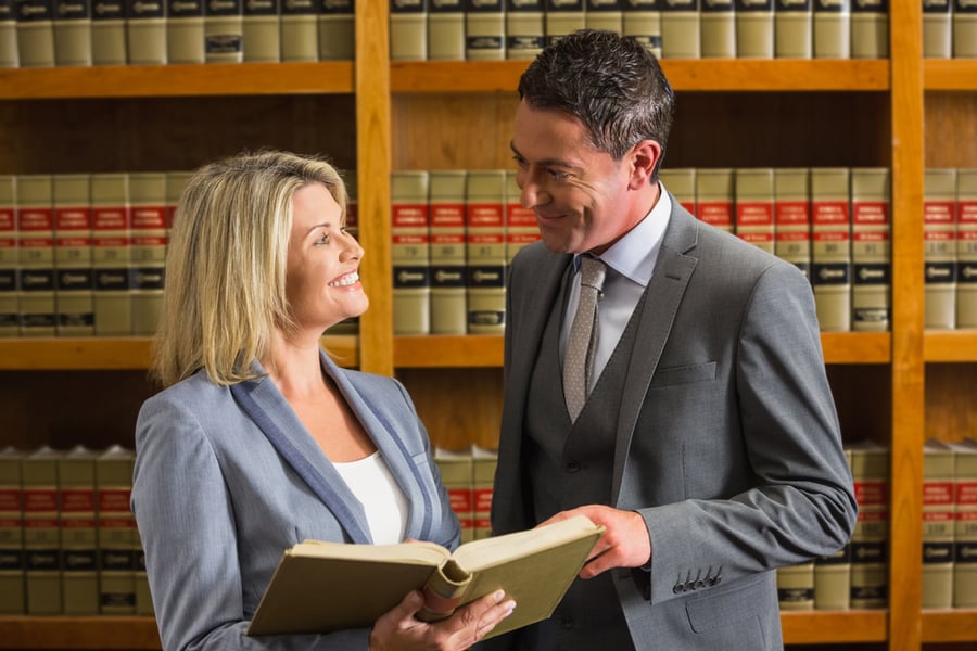 Lawyers reading book in the law library at the university