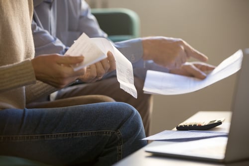 Couple filing taxes in living room