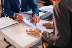 Businessman reviewing documents with woman