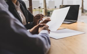 Lawyer looking at document with client