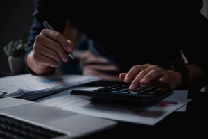Businessman using calculator for taxes