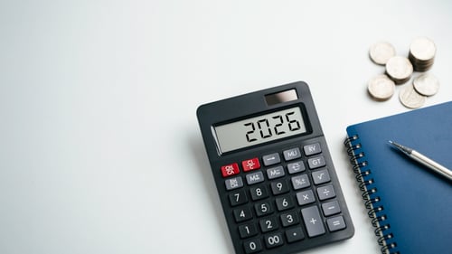Calculator displaying 2026 year on desk for financial and tax planning