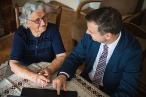 elderly woman speaking with a tax attorney